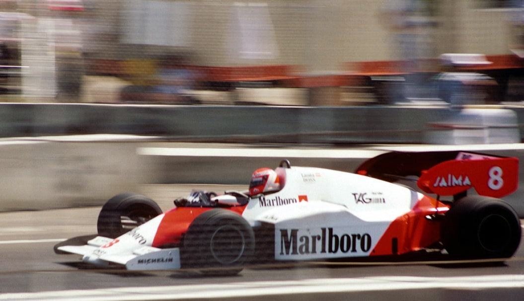Mclaren TAG 1980s Formula 1 car on a racetrack with Marlboro branding driven by Niki Lauda