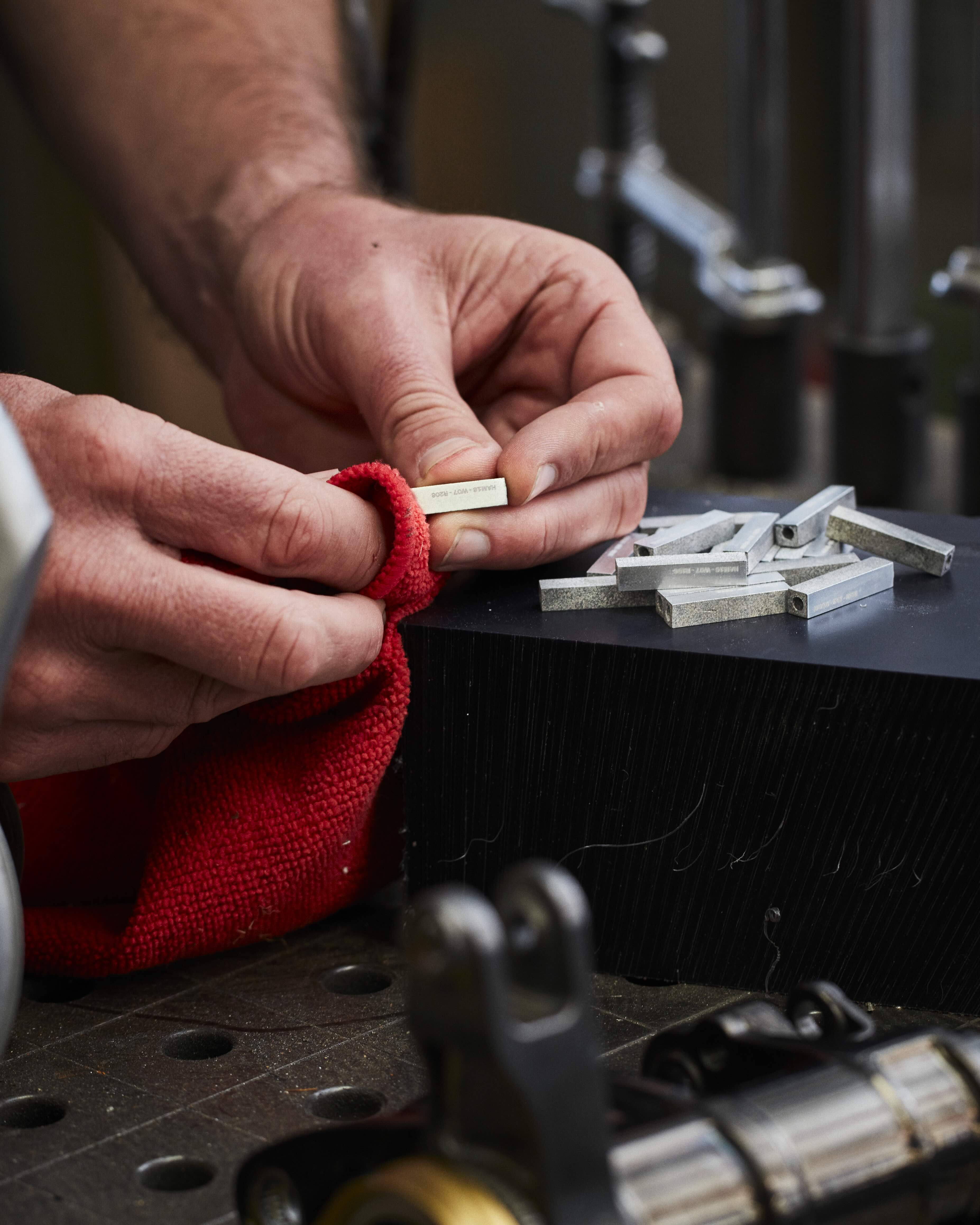 RESS Jewellery blocks which are made from F1 Cars being polished by hand in the RESS Factory. 