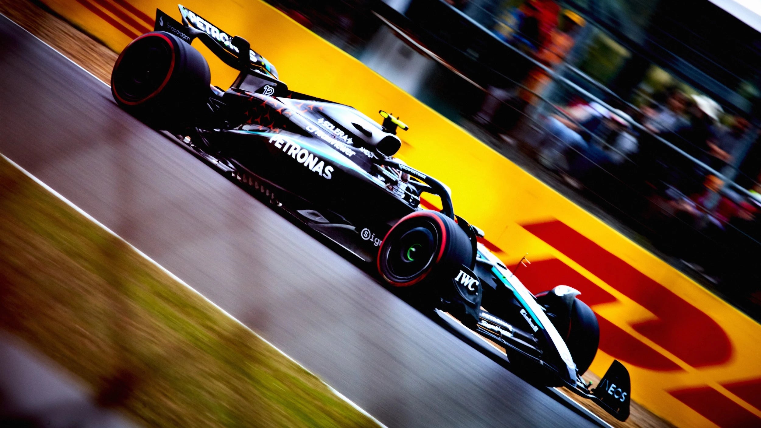 Mercedes Formula 1 car racing on a F1 Grand Prix track with a blurred background