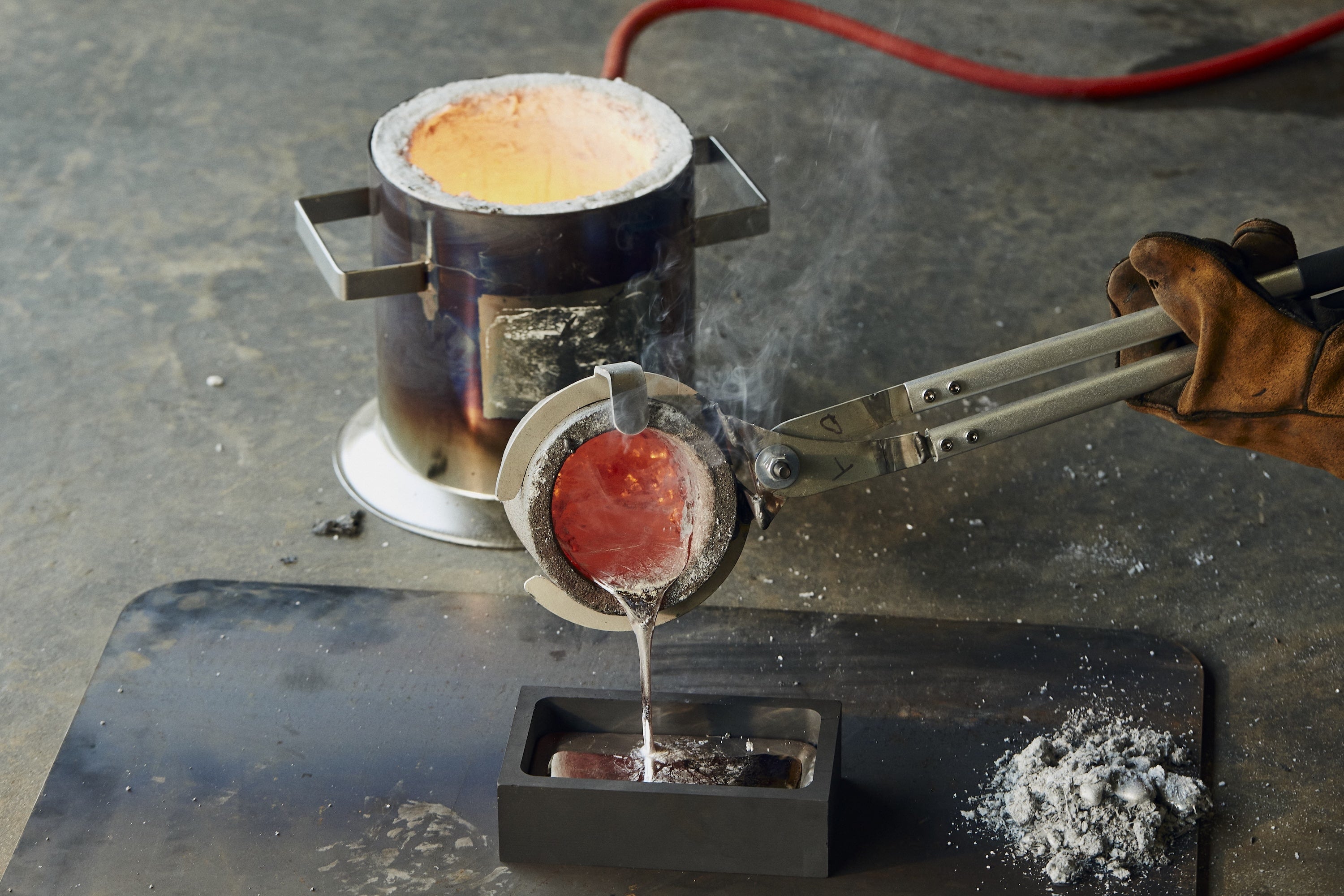 RESS Jewellery making process. The metal being poured into the mould.